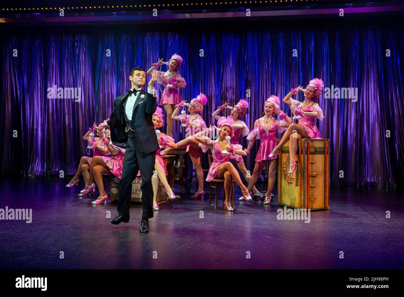 Charlie Stemp (Bobby Child) with the Zangler Follies girls in CRAZY FOR YOU at the Chichester Festival Theatre, Chichester, West Sussex, England  opening on 19/07/2022 music & lyrics: George & Ira Gershwin  book: Ken Ludwig  co-conceived by Ken Ludwig & Mike Ockrent  set design: Beowulf Boritt  costumes: William Ivey Long  lighting: Ken Billington  choreography & direction: Susan Stroman Stock Photo