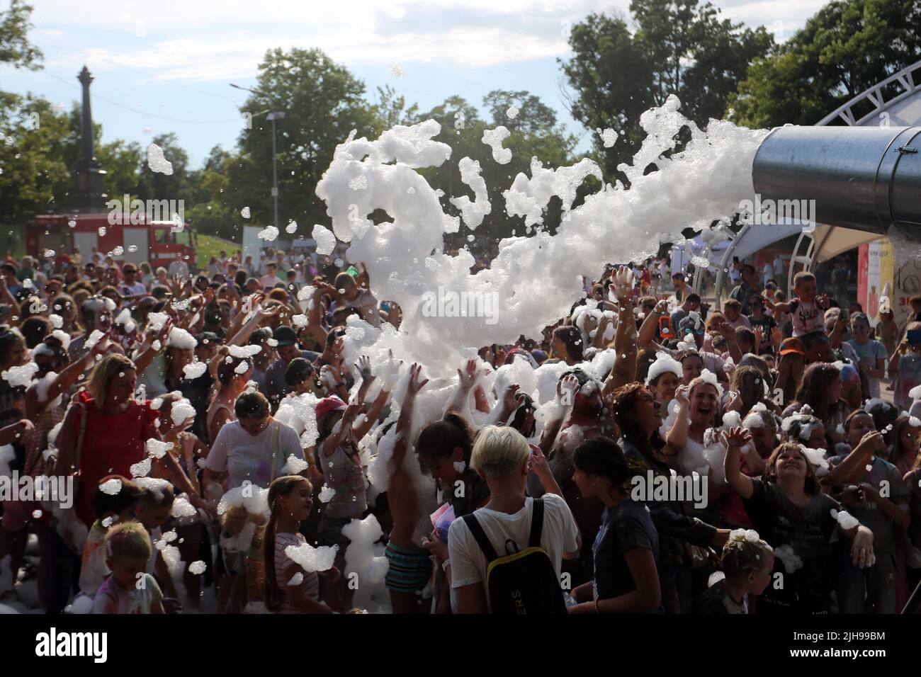 People covered in foam seen dancing during the event. As a holiday