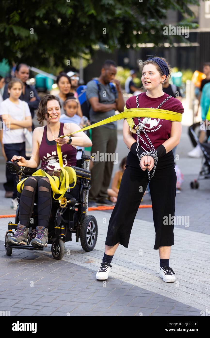 EDITORIAL USE ONLY Escapologists Tianna and Lea perform to crowds during the annual International Busking Day event at Wembley Park, London. Picture date: Saturday July 16, 2022. Stock Photo