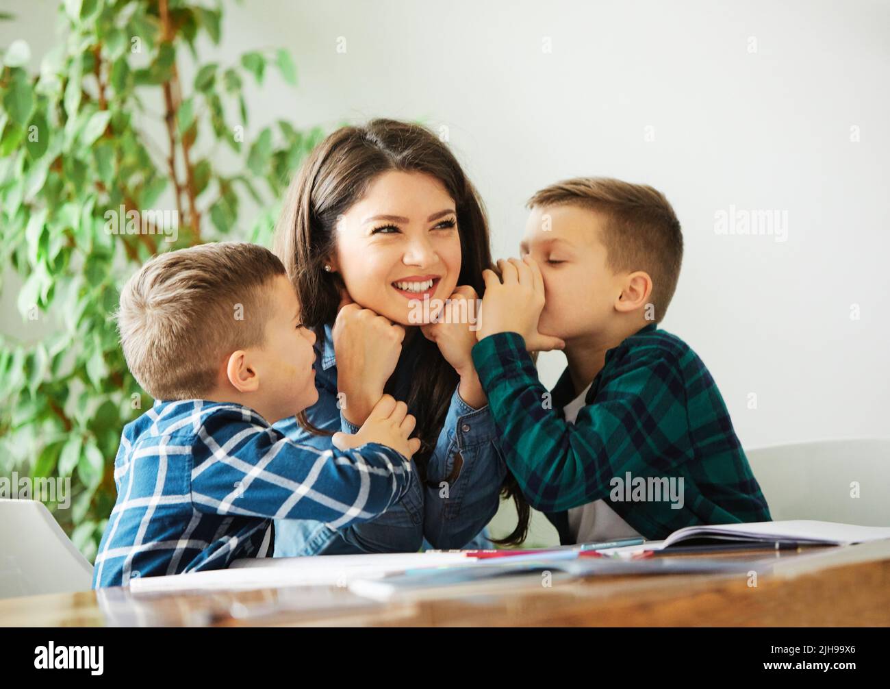 homework teaching boy education mother children son familiy childhood chil kiss kissing boy love Stock Photo