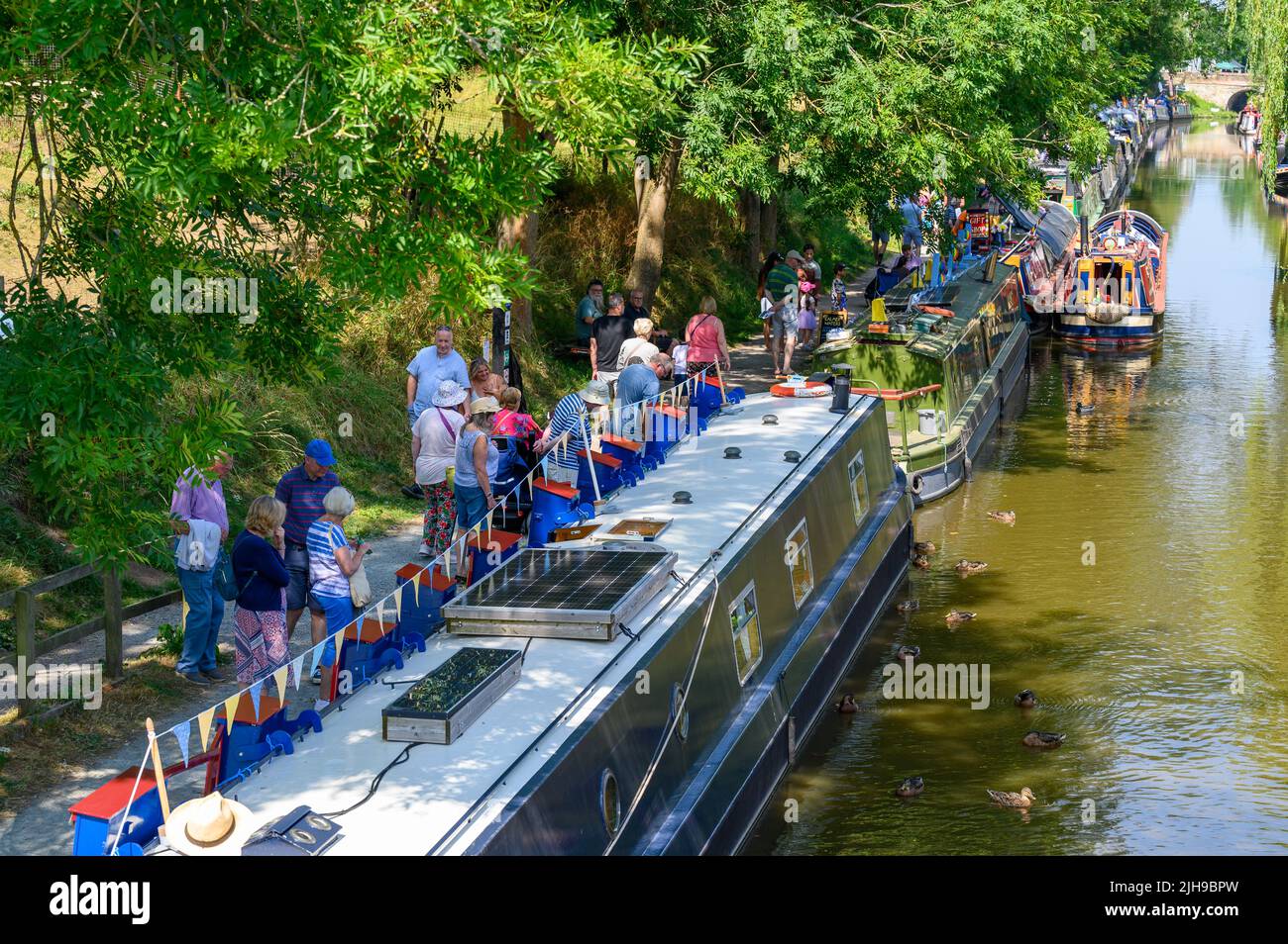 Visitors enjoying a canal festival in the village of Gnosall in Staffordshire during a heatwave. Stock Photo