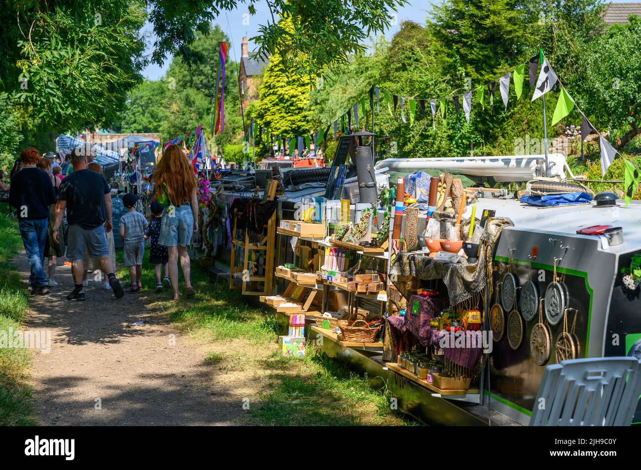 Visitors enjoying a canal festival in the village of Gnosall in Staffordshire during a heatwave. Stock Photo