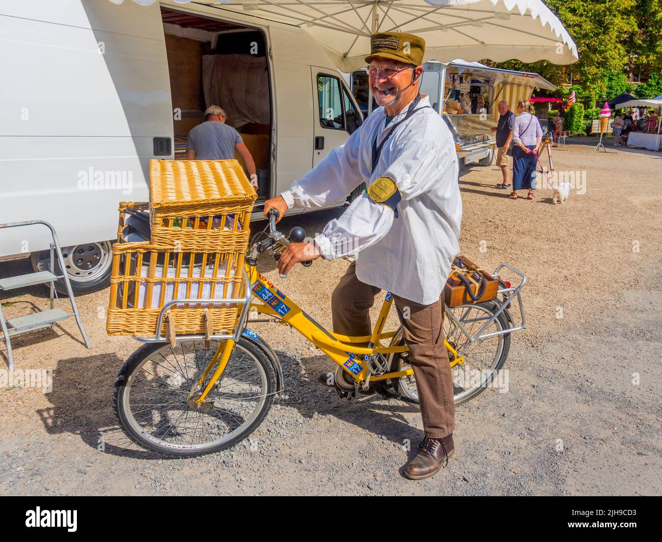 Street fair information organiser on bicycle - Angles-sur-l'Anglin, Vienne (86), France. Stock Photo
