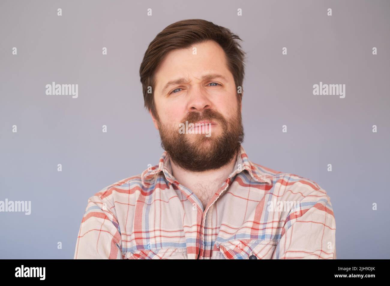 Man with unhappy expression as feels frustration, being upset to hear bad news Stock Photo