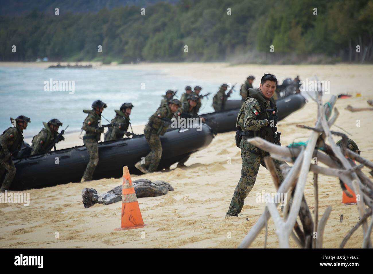 220715-N-EE352-1226  BELLOWS AIR FORCE STATION, Hawaii (July 15, 2022) Mexican Naval Infantry Capt. Isai Fernandez, assigned to Mexican Marine 8th Brigade, directs his team next to combat rubber raiding crafts during an amphibious operations training with the U.S. Marine Corps at Bellows Beach during Rim of the Pacific (RIMPAC) 2022. Twenty-six nations, 38 ships, four submarines, more than 170 aircraft and 25,000 personnel are participating in RIMPAC from June 29 to Aug. 4 in and around the Hawaiian Islands and Southern California. The world's largest international maritime exercise, RIMPAC pr Stock Photo