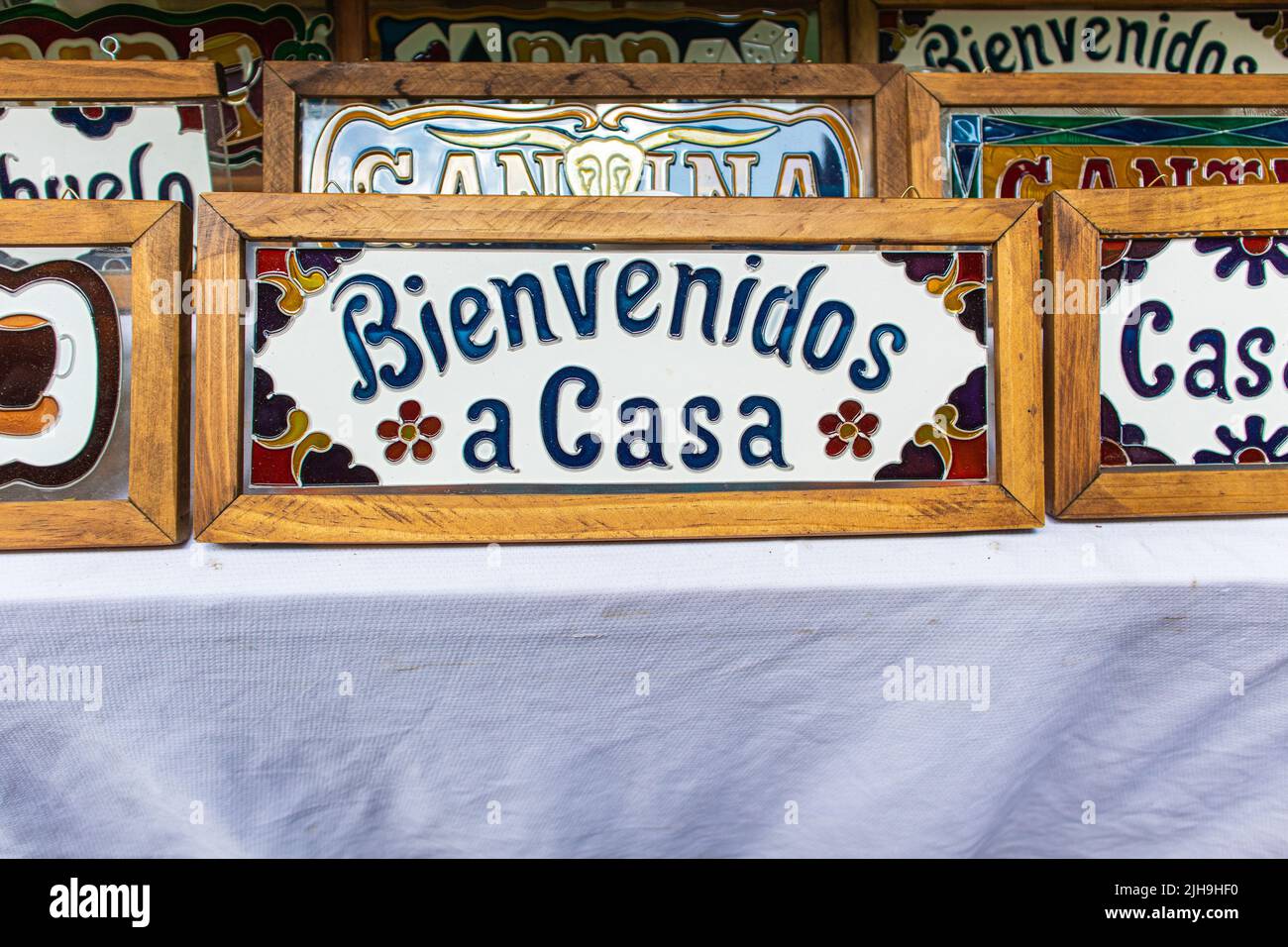 Welcome home colorful sign written in spanish that says bienvenidos a casa  at sale in a street market at Los Sapos magic town in Puebla city, Mexico  Stock Photo - Alamy