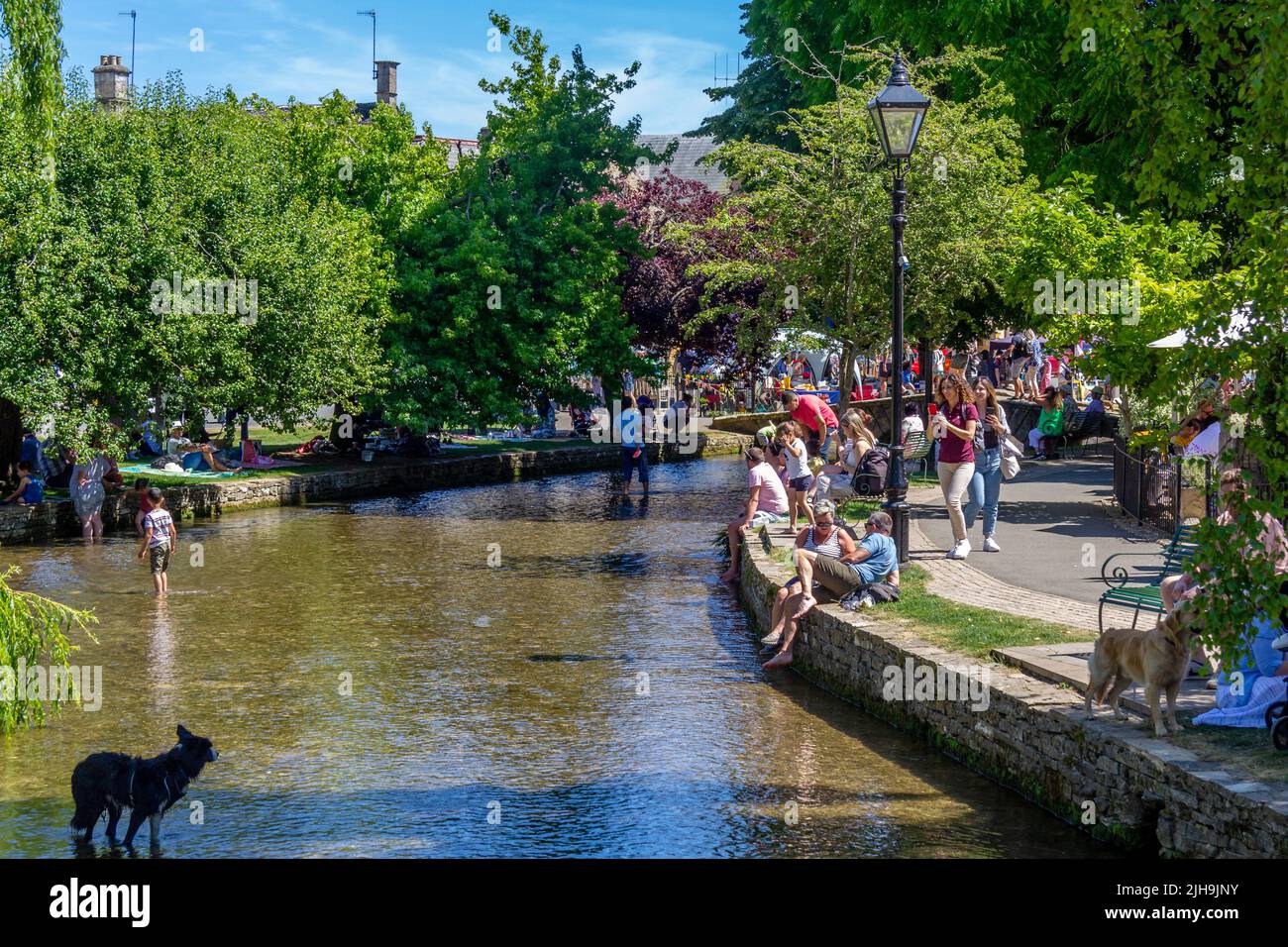 Crowds by River Windrush in Bourton on the Water on a hot summer day