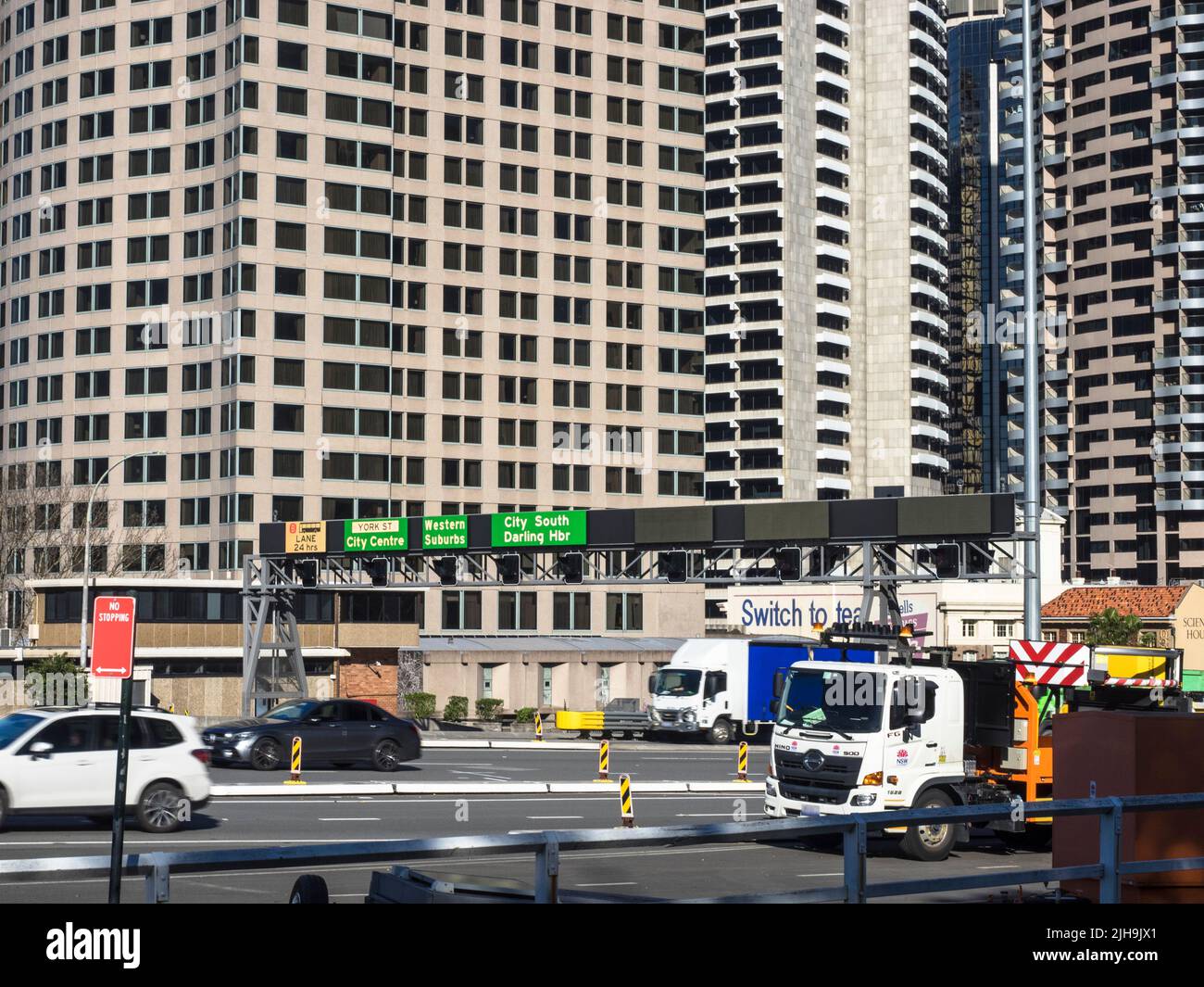 Vehicles leaving Sydney's CBD for the Harbour Bridge. Freeway destination signs show the options on entering the city. Stock Photo