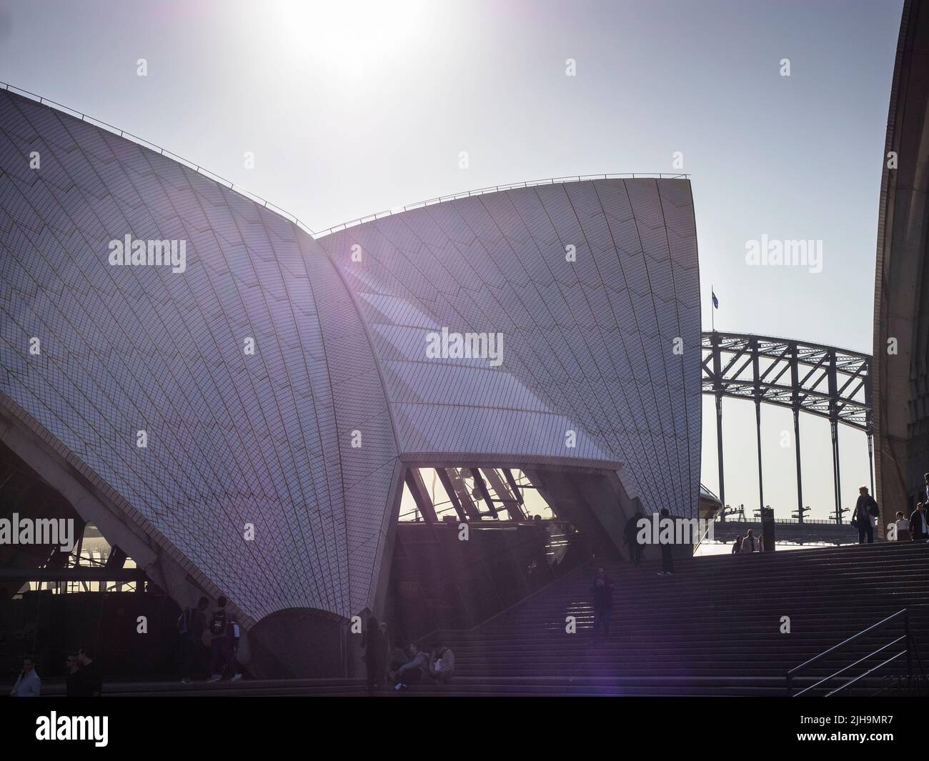 Closeup of the Restaurant Shell of the Sydney Opera House with the Harbour Bridge in the background. Stock Photo