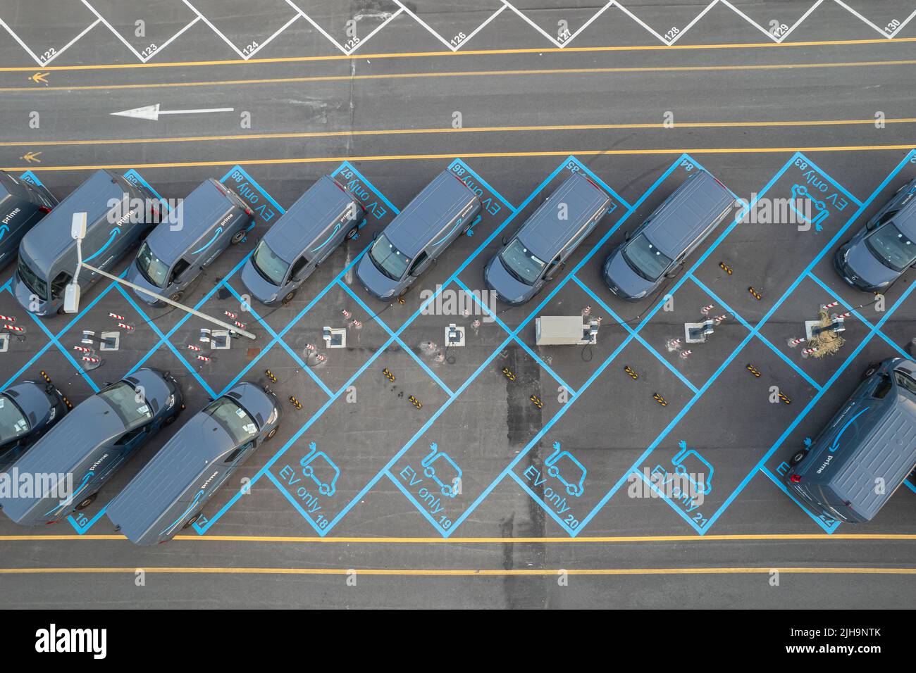 Top view of Amazon Prime electric delivery vans, parked at  the logistics hub of Amazon. Turin, Italy - July 2022 Stock Photo