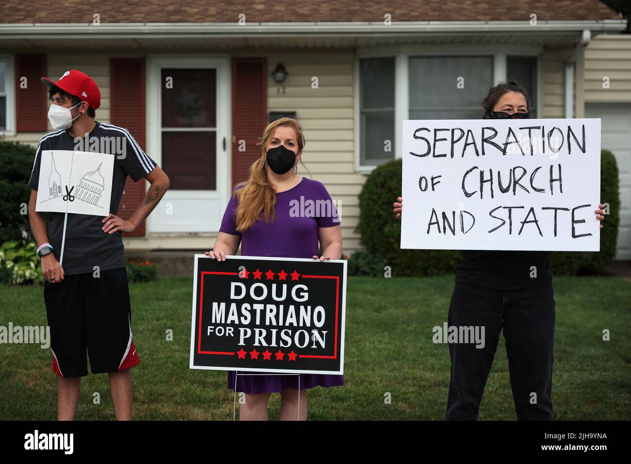 People demonstrate against Doug Mastriano, Republican gubernatorial candidate from Pennsylvania, during his meet and greet with supporters before the screening of the documentary 'The Return of the American Patriot: The Rise of Pennsylvania' at Christ Community Church in Camp Hill, Pennsylvania, U.S., July 16, 2022. REUTERS/Shannon Stapleton Stock Photo
