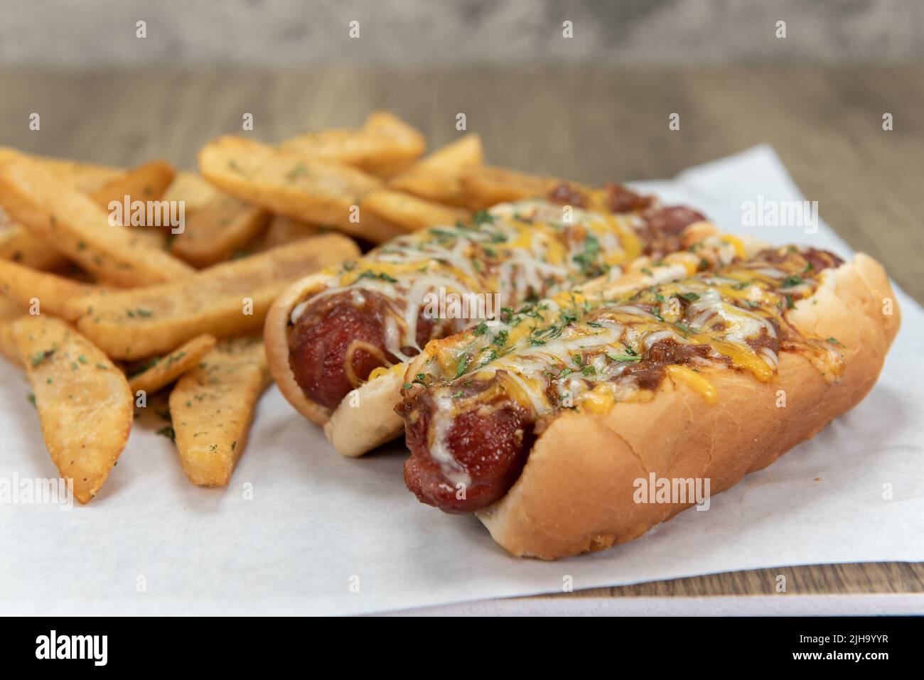 Pair of chili cheese dog hotdogs loaded with melted cheese and served