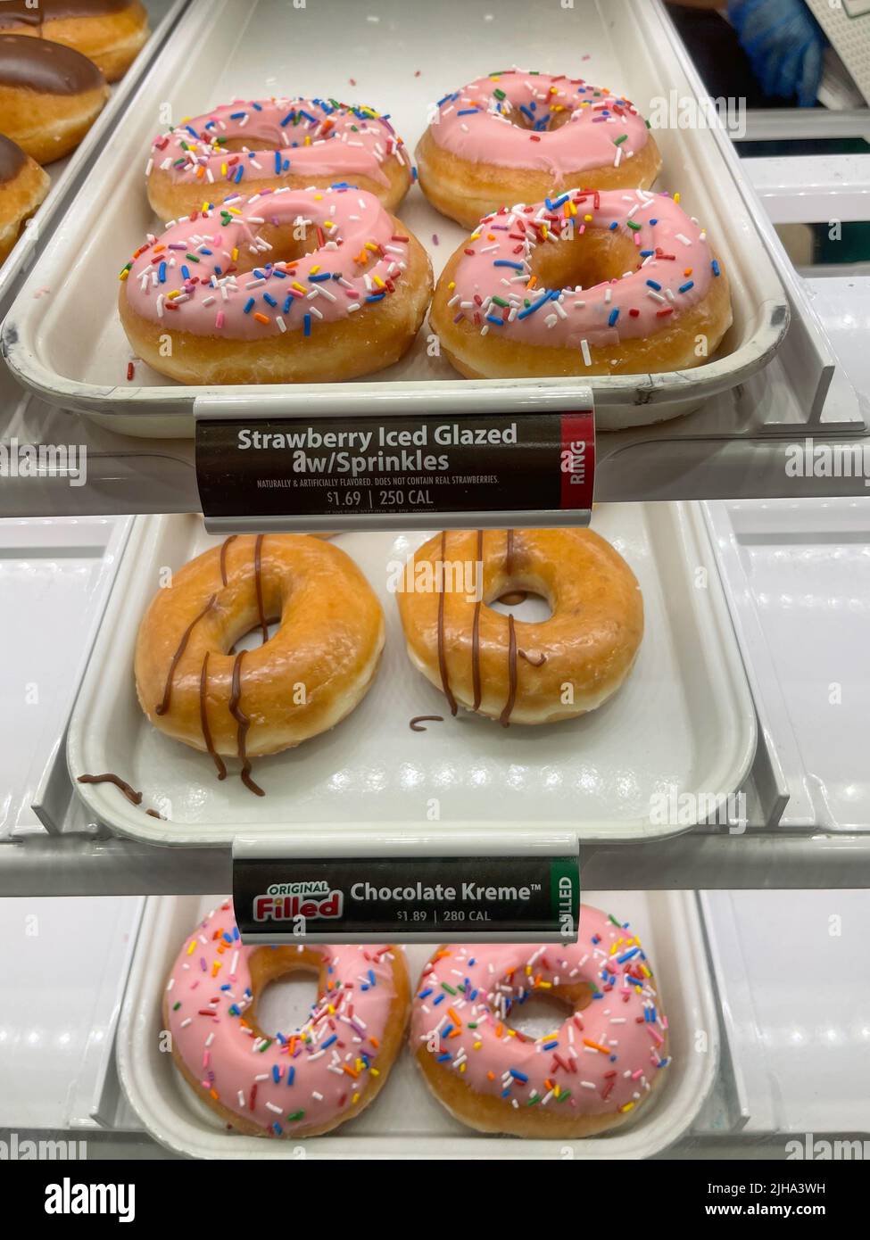 Famous Krispy Kreme for sale in display case.  Stock Photo