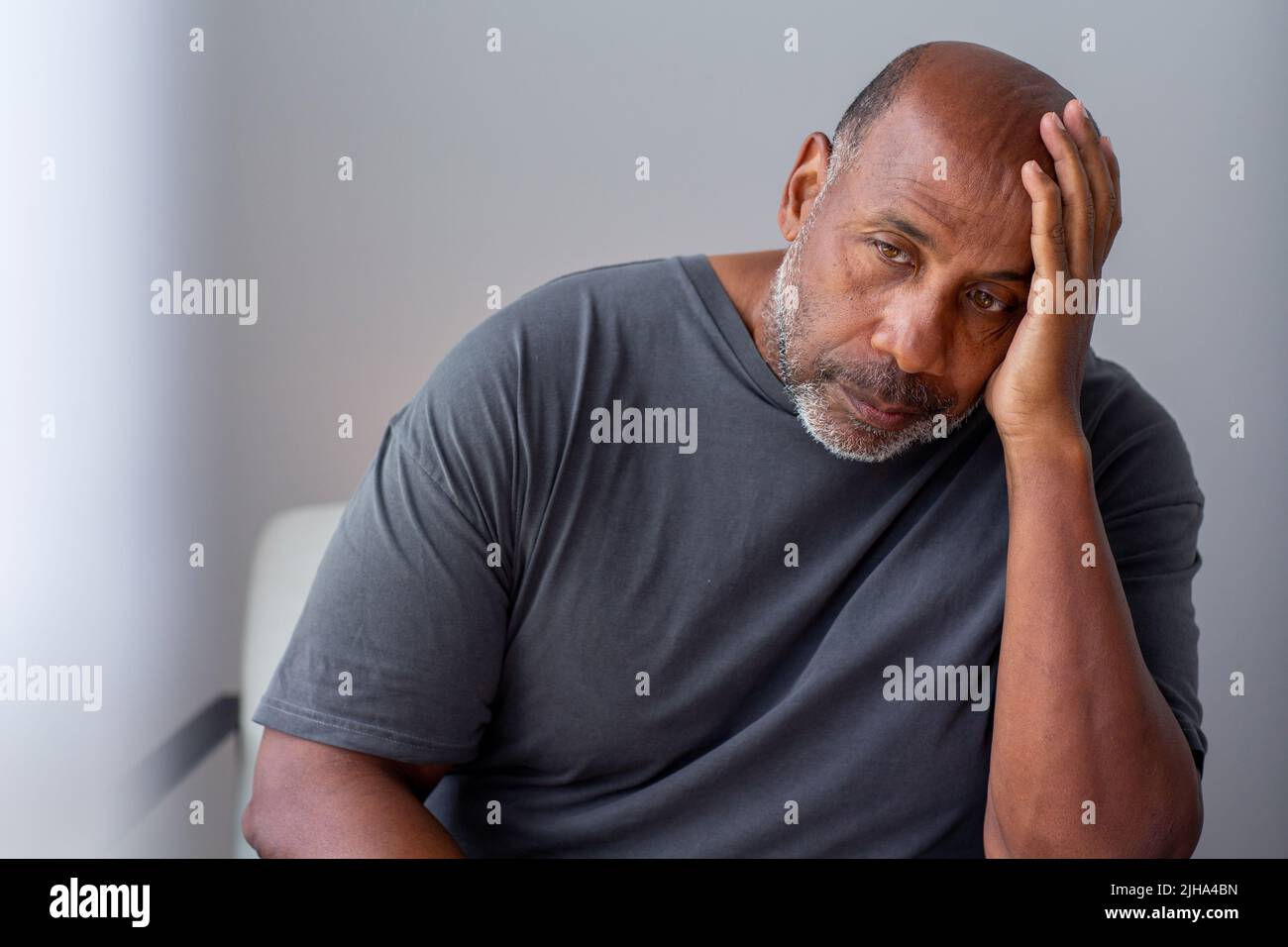 Mature African American man not feeling well with his hands on his head. Stock Photo