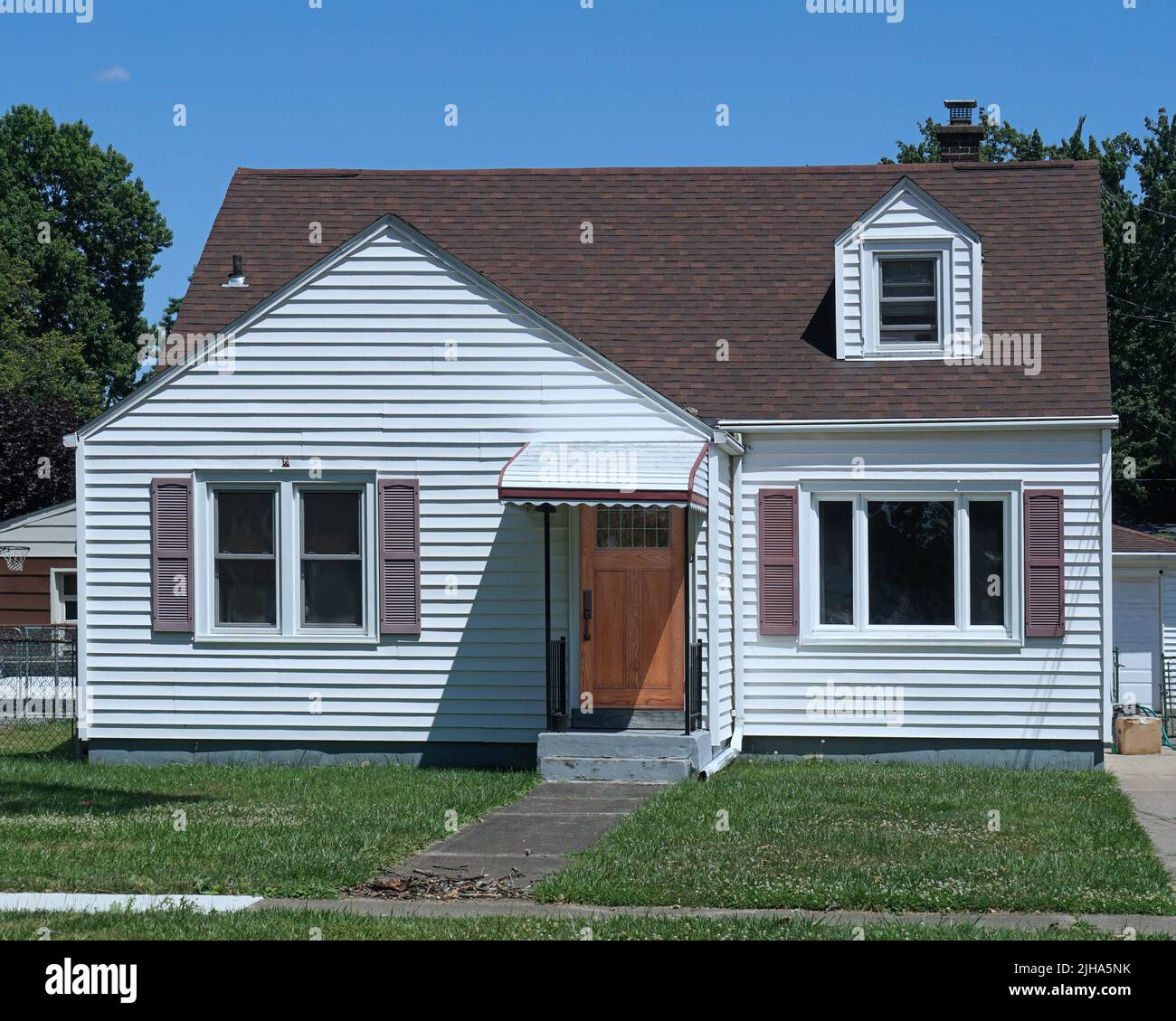 Average American house, white clapboard with gable and front lawn Stock Photo