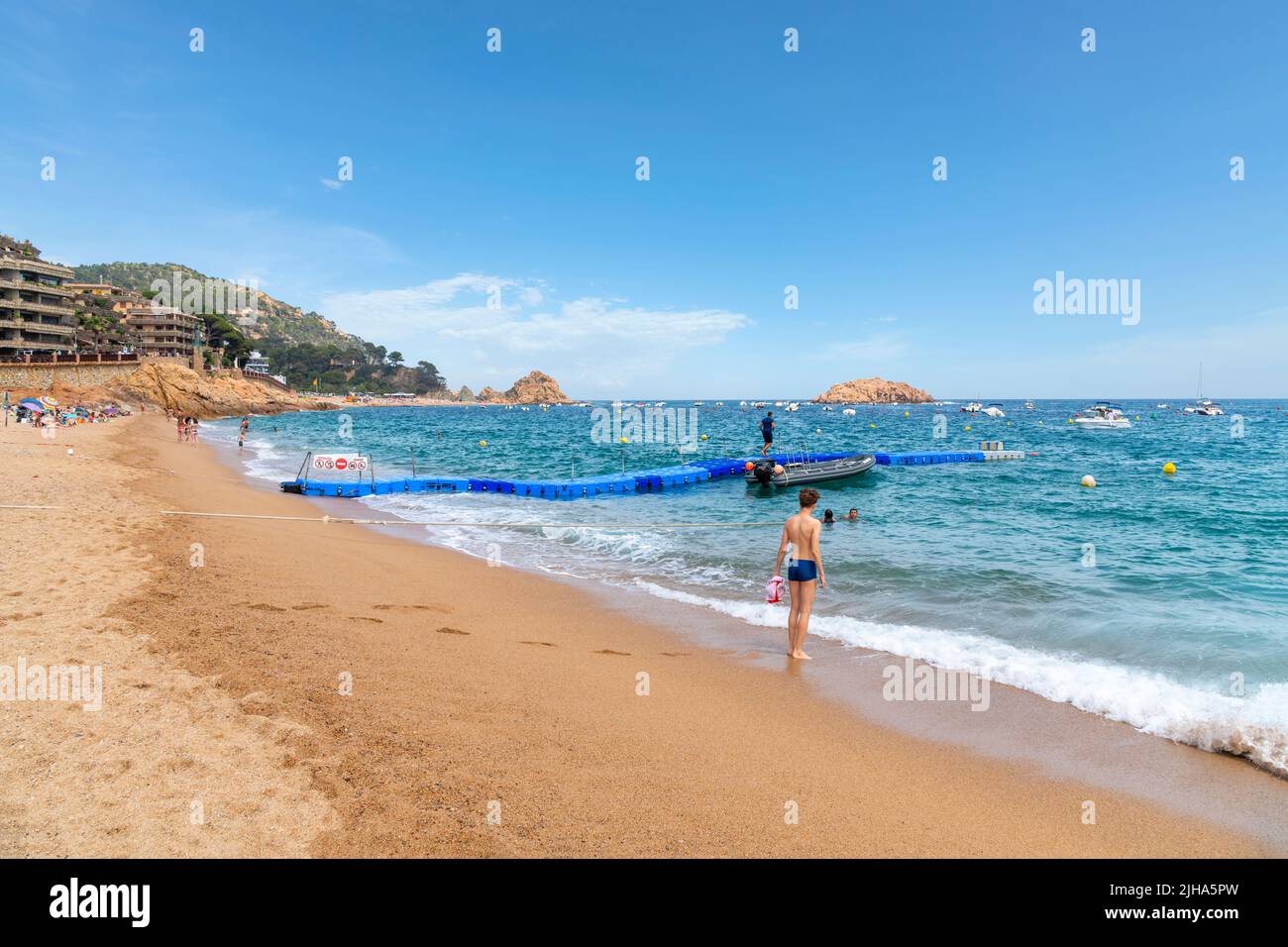 The sandy Platja Gran beach at the resort town of Tossa de Mar, Spain, on the Costa Brava coast of the Mediterranean Sea. Stock Photo