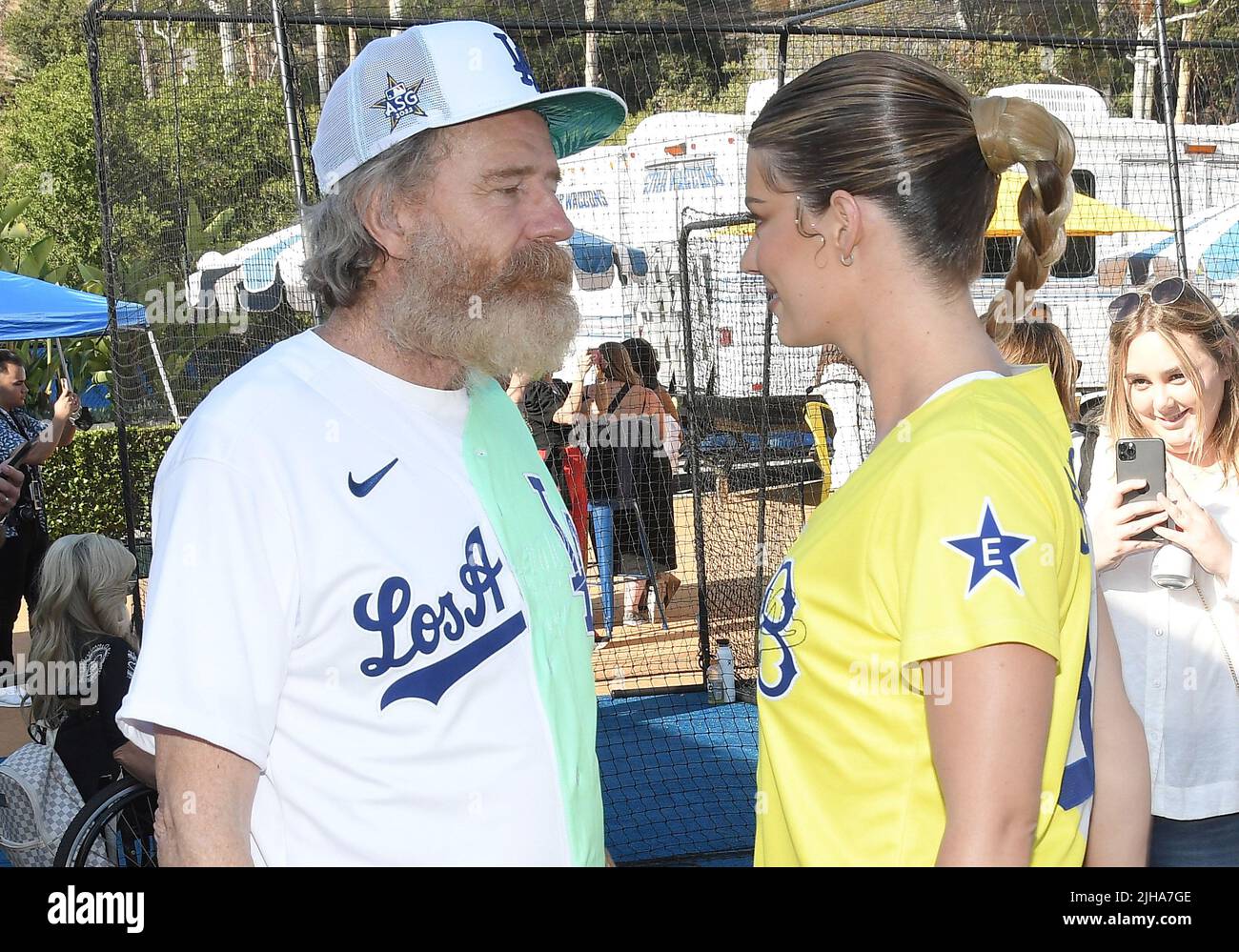 Los Angeles, USA. 16th July, 2022. (L-R) Bryan Cranston and Hannah Stocking  in a face off at the 2022 MLB All-Star Celebrity Softball Game Media  Availability held at the 76 Station 