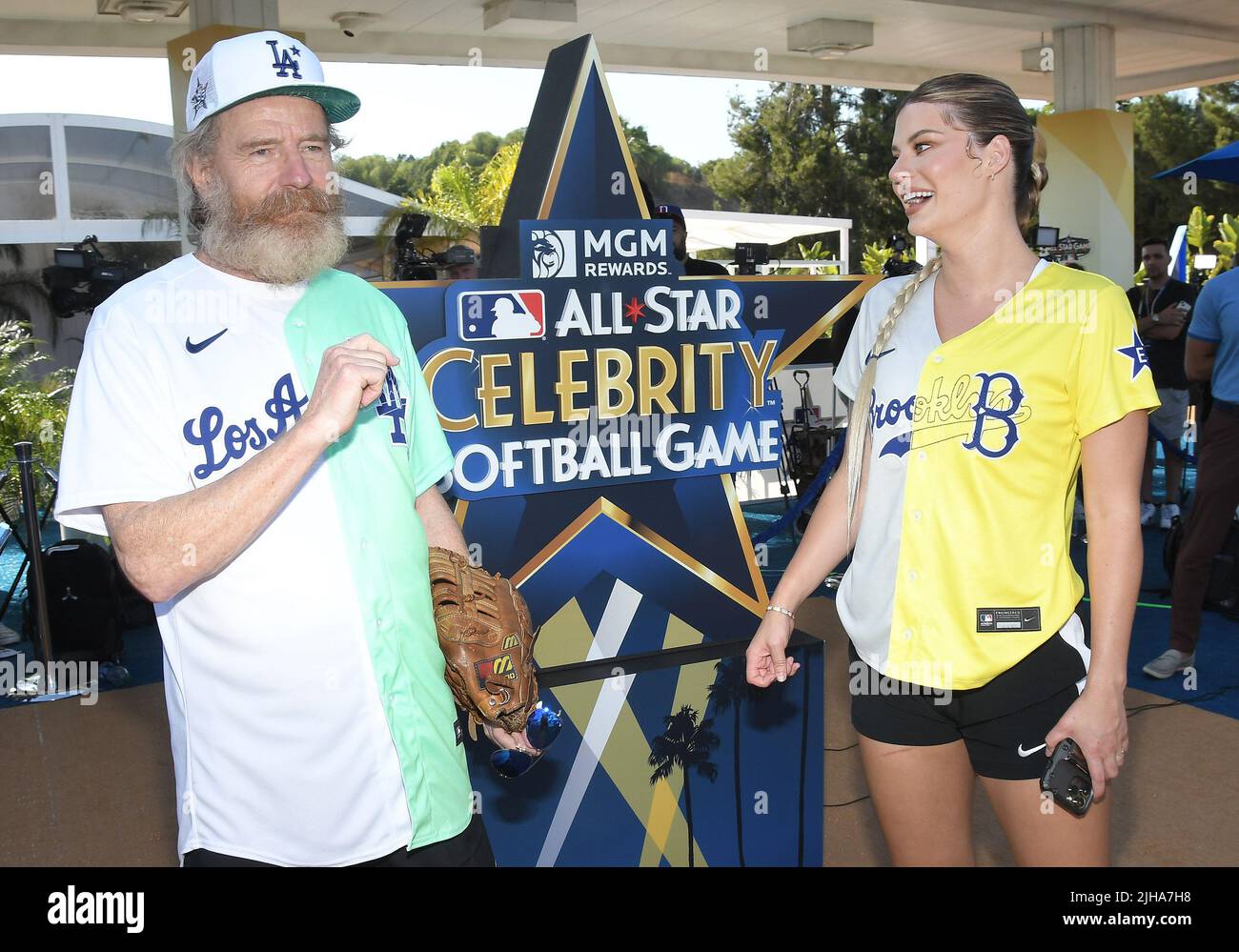 Los Angeles, USA. 16th July, 2022. (L-R) Bryan Cranston and Hannah Stocking  in a face off at the 2022 MLB All-Star Celebrity Softball Game Media  Availability held at the 76 Station 