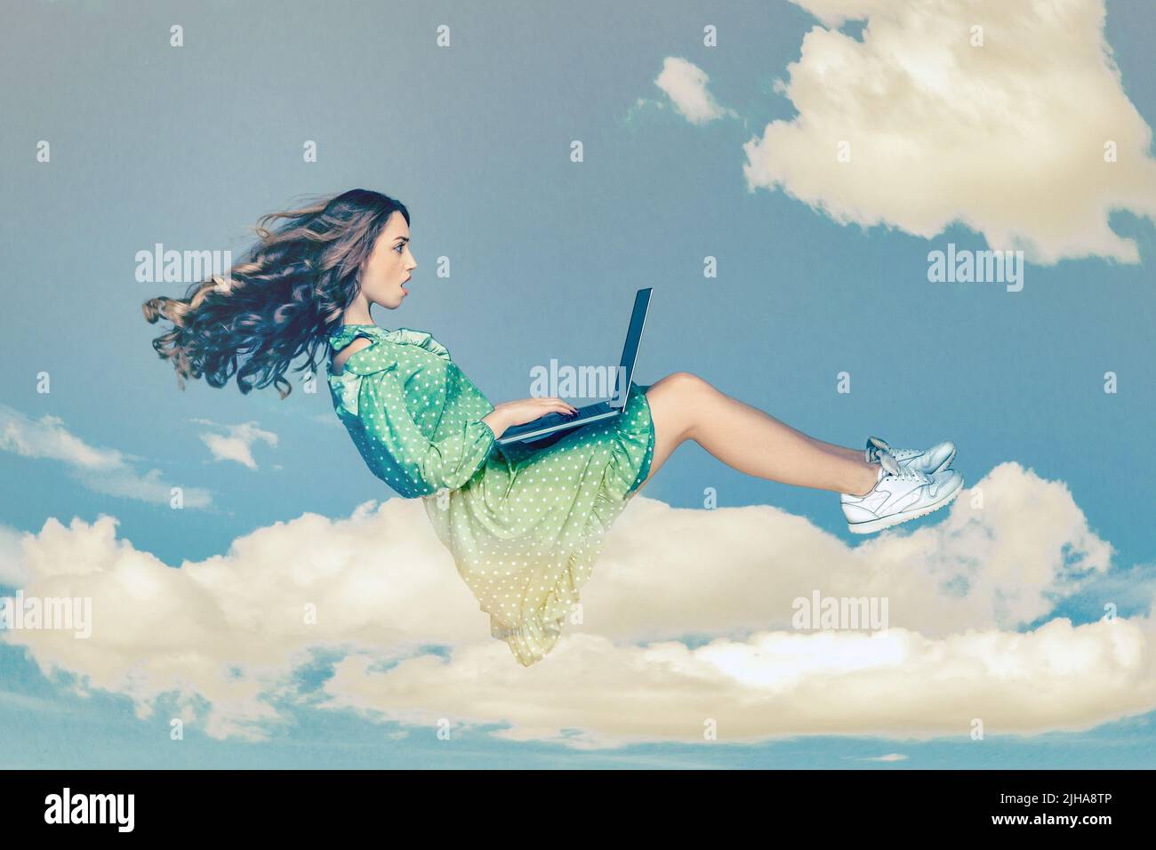 Hovering in air. Surprised girl ruffle dress levitating, looking at laptop screen shocked amazed, surfing web social networks while flying in mid-air. collage composition on day cloudy blue sky Stock Photo