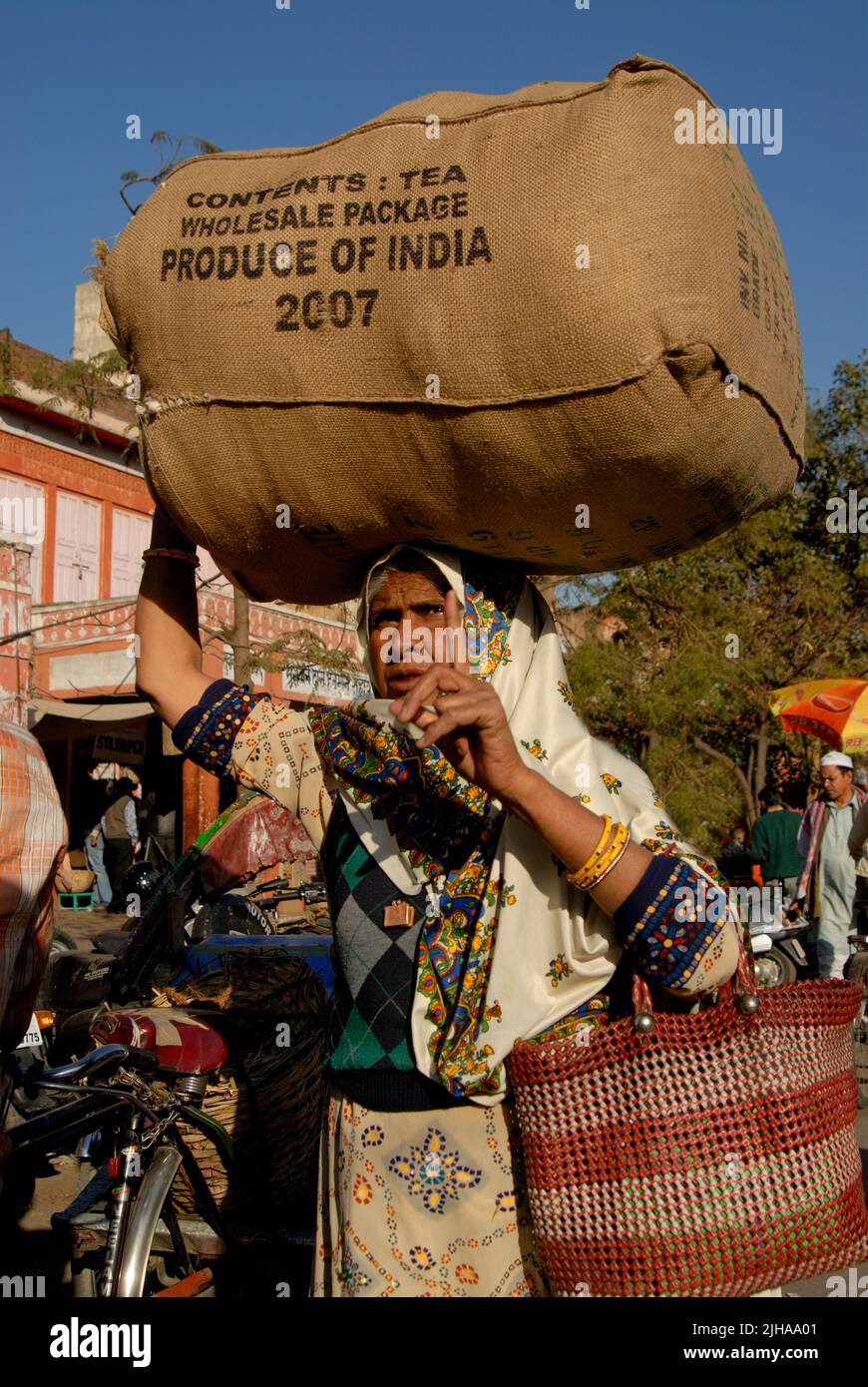 Woman worker carry a sack of tea - product of India Stock Photo