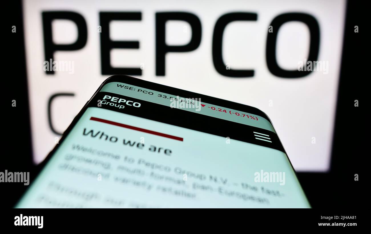Mobile phone with website of retail company Pepco Group N.V. on screen in front of business logo. Focus on top-left of phone display. Stock Photo