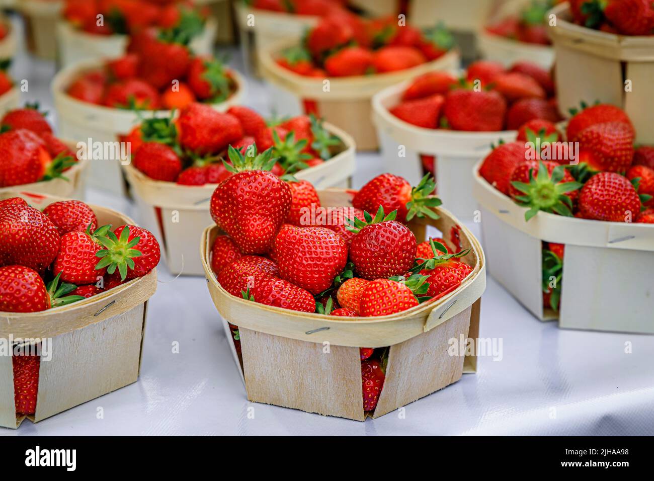 Ripe red strawberries on a stand at a local outdoor farmers market Cours Saleya in the Old Town, Vieille Ville in Nice, French Riviera, France Stock Photo