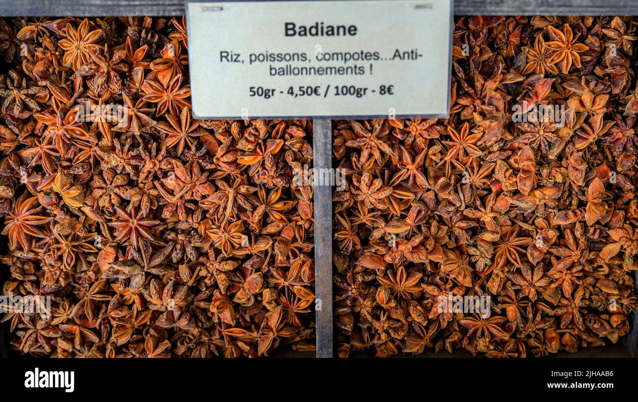 Star anise with a sign suggesting use for rice, fish, compote and bloating at a local farmers market Cours Saleya in Old Town Nice, South of France Stock Photo