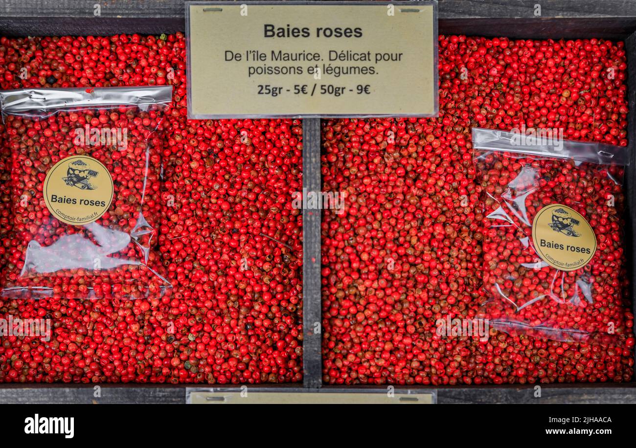 Red peppercorns from Mauritius with a sign suggesting use for fish and vegetables at a farmers market Cours Saleya in Old Town Nice, South of France Stock Photo