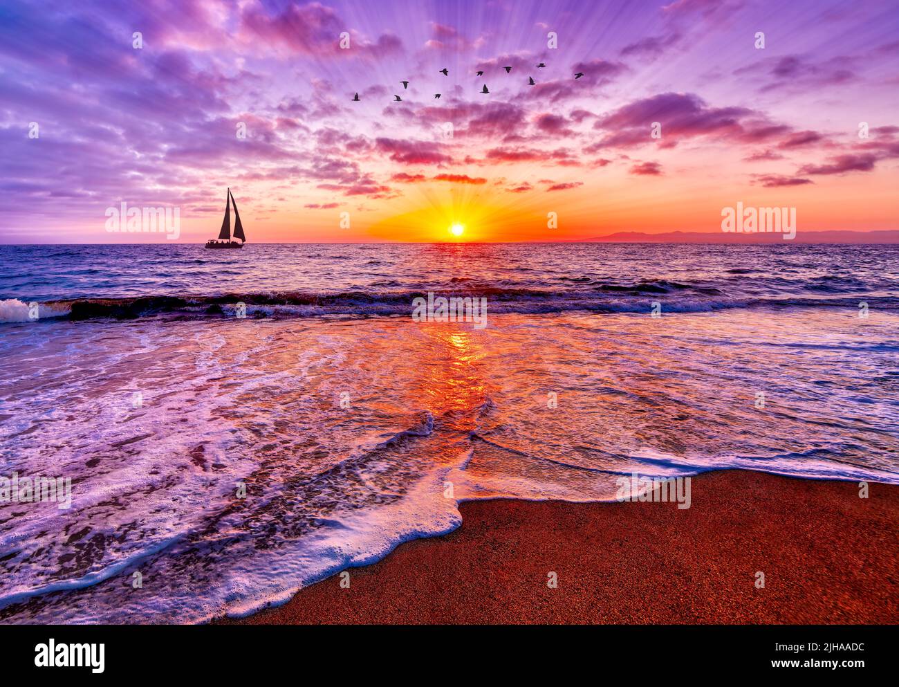 Sun Rays Are Bursting On The Ocean Horizon Sunrise With A Sailboat Sailing And Birds Flying Overhead Stock Photo