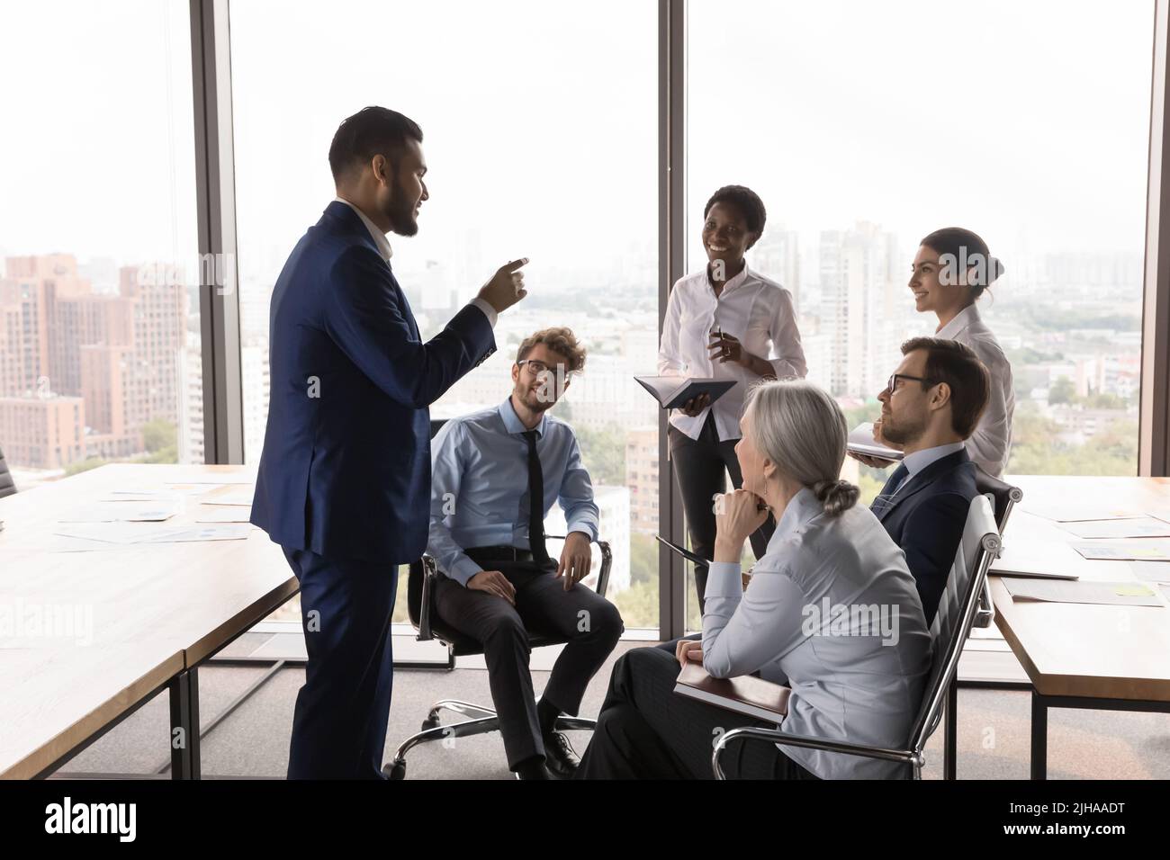 Young executive, project leader meeting with managers, speaking Stock Photo