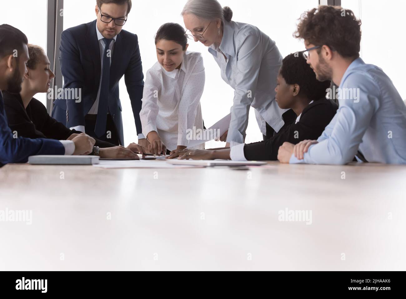 Multiethnic different aged marketing group discussing paper reports Stock Photo