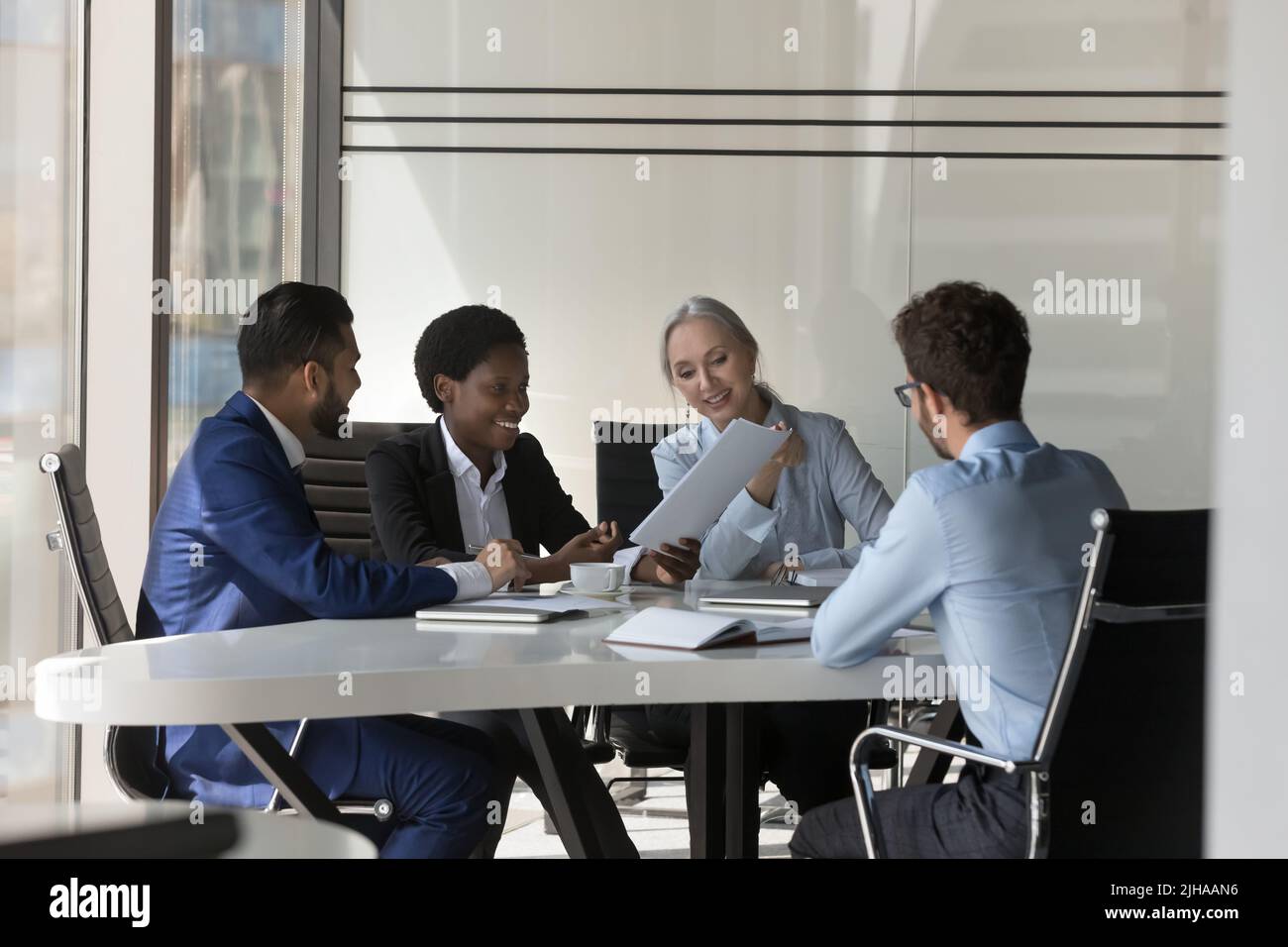 Different aged diverse HR team interviewing job candidate Stock Photo