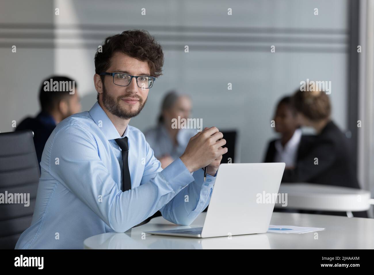 Confident handsome young professional man portrait at laptop Stock Photo