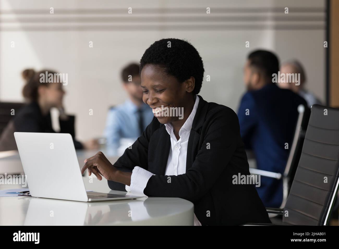 Happy young african woman typing hi-res stock photography and images ...