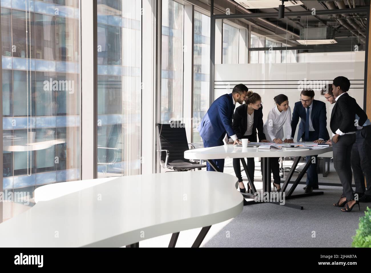 Multiethnic millennial business group of employees brainstorming on project Stock Photo
