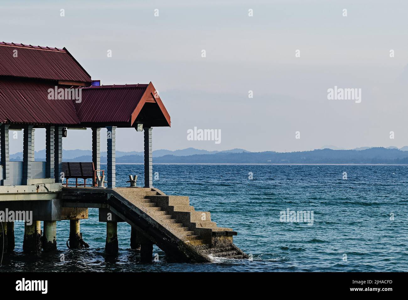 Seashore Building A building on a seashore with stairs leading to water on a mountain ...