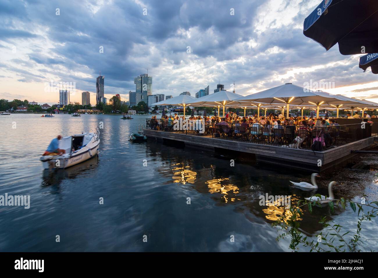 Wien, Vienna: oxbow lake Alte Donau (Old Danube), sunset, floating restaurant Strandcafe, Donaucity with DC Tower 1 and IZD Tower, Donauturm (Danube T Stock Photo