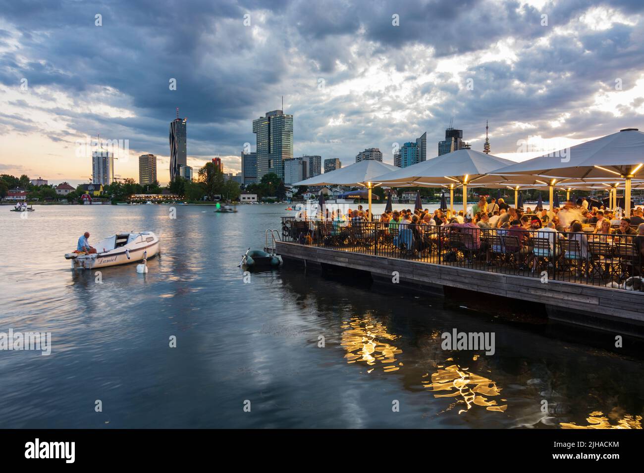 Wien, Vienna: oxbow lake Alte Donau (Old Danube), sunset, floating restaurant Strandcafe, Donaucity with DC Tower 1 and IZD Tower, Donauturm (Danube T Stock Photo