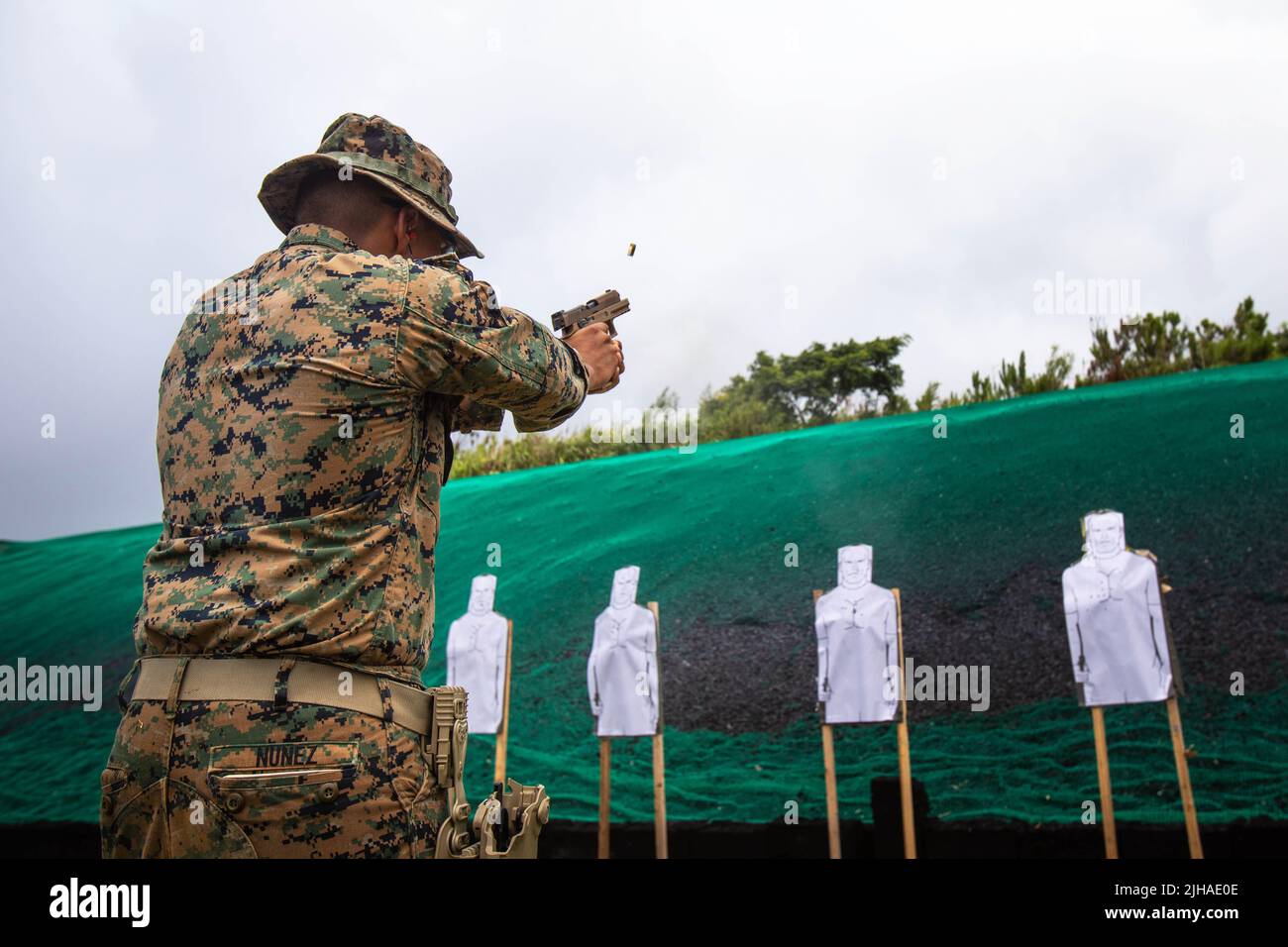 Camp Hansen, Okinawa, Japan. 7th July, 2022. U.S. Marine Corps Lance Cpl. Andrew Nunez, a mortarman with 3d Battalion, 3d Marines, fires an M18 Modular Handgun System during a Combat Marksmanship Program range at Camp Hansen, Okinawa, Japan, July 7, 2022. This training sharpened Marines' critical combat arms skills by executing transition drills and increasing their proficiency in switching between primary and secondary weapons. 3/3 is forward deployed in the Indo-Pacific under 4th Marines, 3d Marine Division as part of the Unit Deployment Program. Nunez is a native of Los Angles, California Stock Photo
