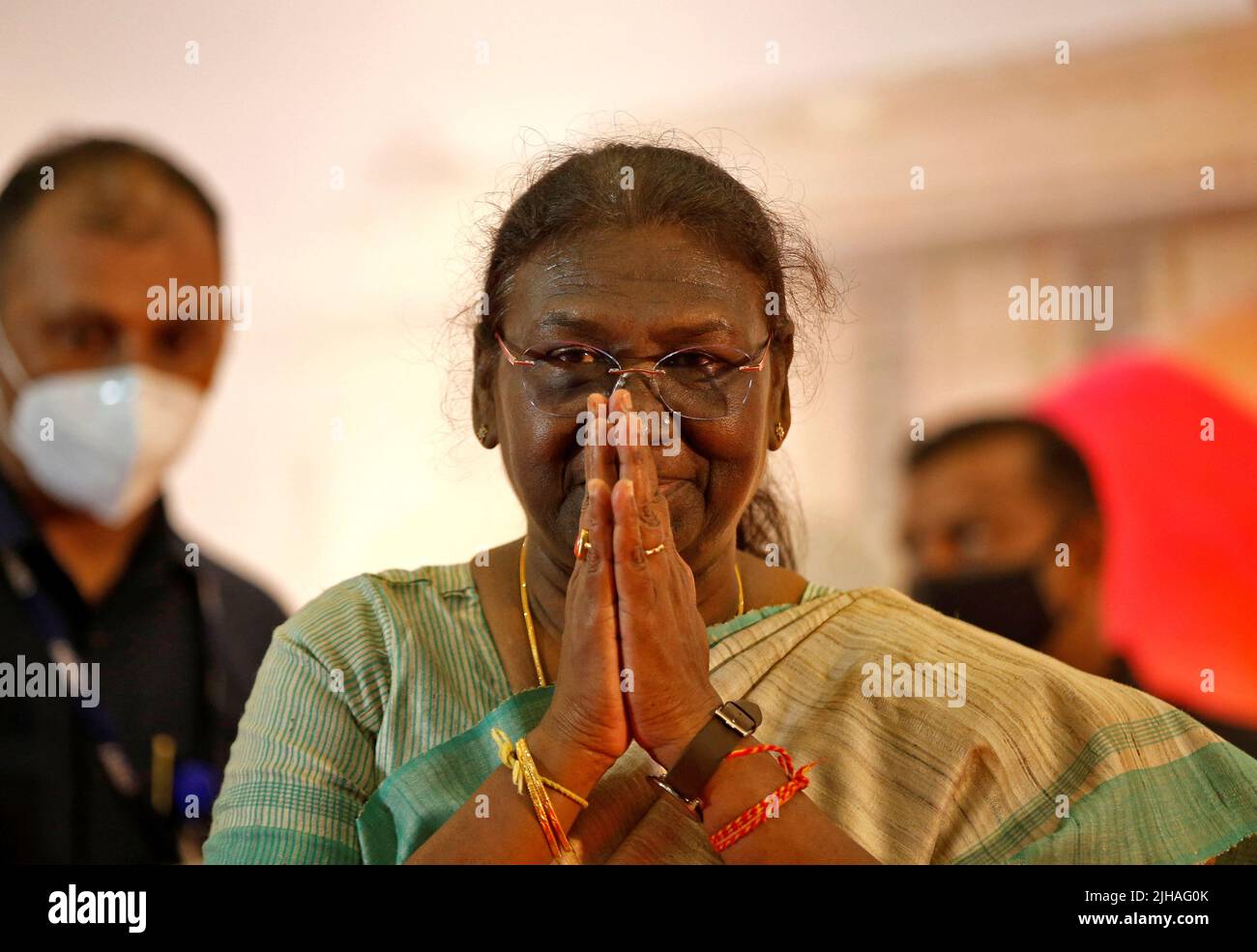 Droupadi Murmu, 64, a female politician who was nominated as presidential candidate by Prime Minister Narendra Modi's ruling Bharatiya Janata Party (BJP), greets an audience as she arrives to attend a meeting ahead of India's presidential elections, in Ahmedabad, India, July 17, 2022. REUTERS/Amit Dave Stock Photo
