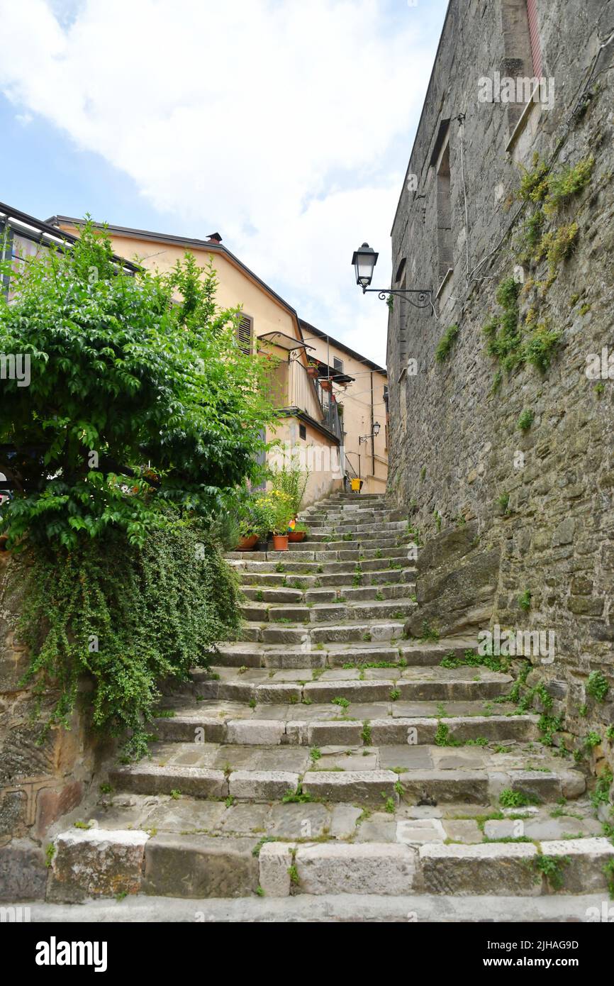 A narrow street between the old houses of Albano di Lucania, a village in the Basilicata region, Italy. Stock Photo