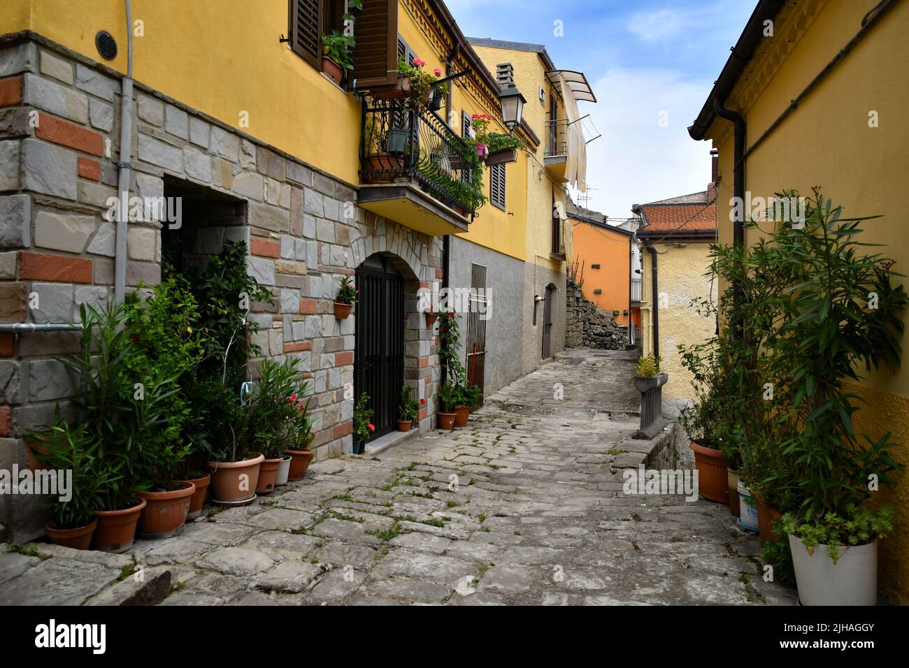 A narrow street between the old houses of Albano di Lucania, a village in the Basilicata region, Italy. Stock Photo