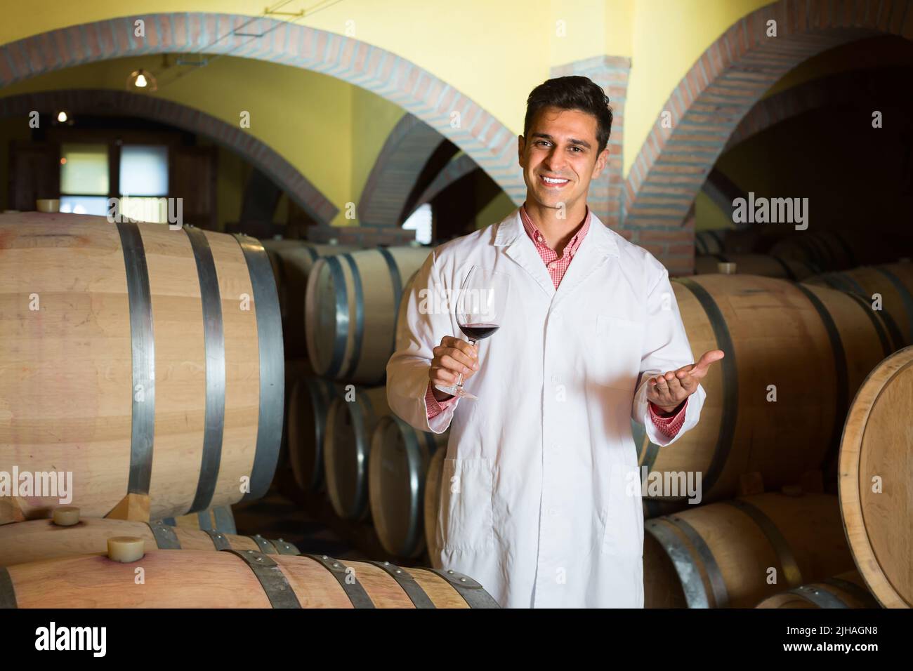 taster of winery with wine in cellar Stock Photo Alamy