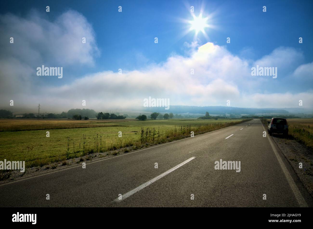 summer road trip in mountain landscape of southern Serbia with mist and morning sun Stock Photo
