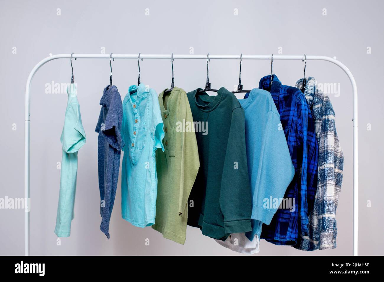 Premium Photo  Large selection of bright, colored children's clothes for a  girl hanging in a closet, on hangers.