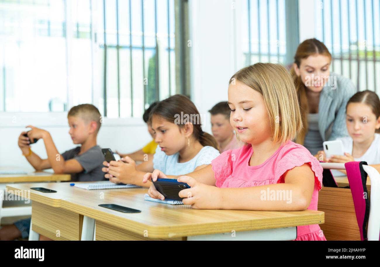 Pupils using mobile phones during lesson in school Stock Photo Alamy