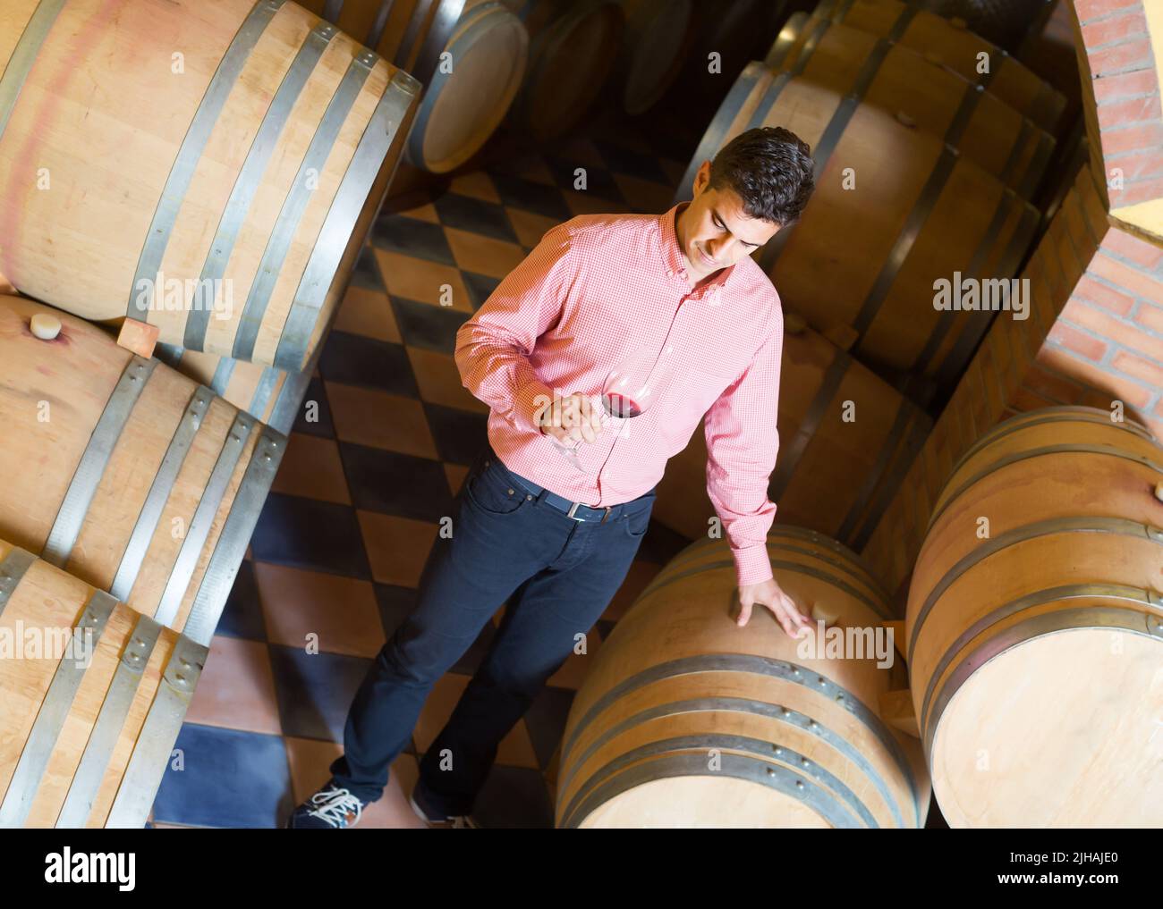 Adult man owner of winery standing with wine Stock Photo - Alamy