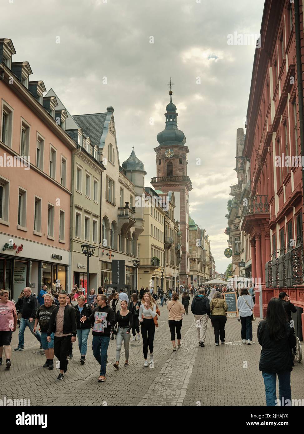 The pedestrians walking along Heidelberg's Hauptstrasse in Germany