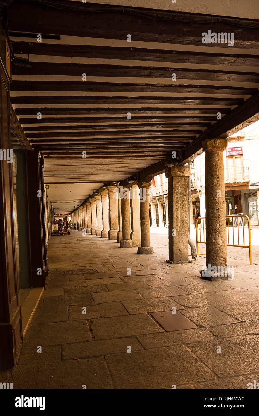 Alcalá de Henares, Spain - June 18, 2022: Historic arcade in the center of Halcalá with stone columns and wooden ceiling Stock Photo