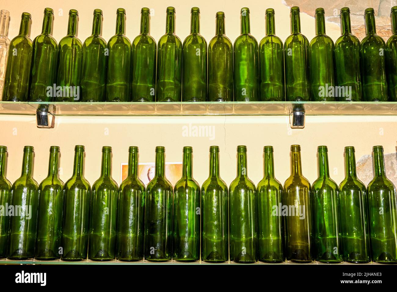 Empty glass bottles on a shelf. Stock Photo
